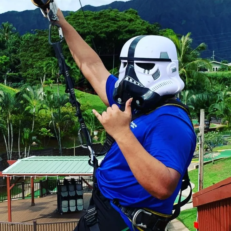 a man standing in front of a fence